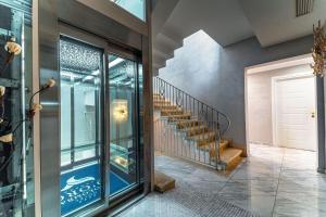 a hallway with a glass door and stairs at Hotel Colomba D'Oro in Tropea