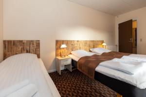 Voodi või voodid majutusasutuse Foldens Hotel toas
