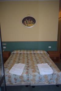 a bedroom with a bed with two towels on it at Hotel River in Civitella Roveto