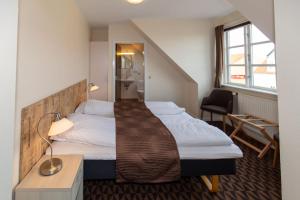 Voodi või voodid majutusasutuse Foldens Hotel toas