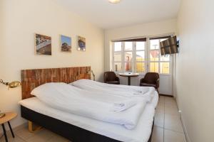 Voodi või voodid majutusasutuse Foldens Hotel toas