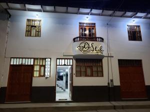 a building with a sign on the front of it at Shale Hotel in Chachapoyas