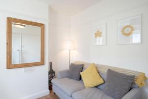 a living room with a couch and a mirror at Avocet House in Wells next the Sea