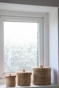 a window with three wicker baskets in front of it at Avocet House in Wells next the Sea