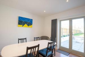 a dining room with a white table and chairs at Avocet House in Wells next the Sea +17 photos
