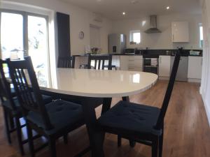 a kitchen and dining room with a table and chairs at Avocet House in Wells next the Sea