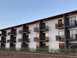 an exterior view of a building with balconies at Hotel Quinta del Bosque in Mazamitla