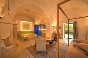 a living room with a hammock in the middle of a room at Masseria Corte degli Aromi in Palmariggi