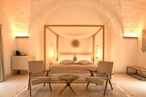 Кровать или кровати в номере Masseria Corte degli Aromi