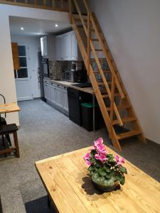 eine Küche mit einem Holztisch mit Blumen darauf in der Unterkunft Cathy et eric in Beaurevoir