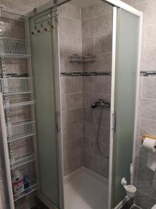 a shower with a glass door in a bathroom at Cathy et eric in Beaurevoir