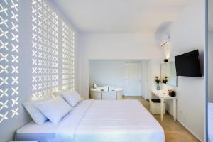 a white bedroom with a bed and a desk at Elia Portou Luxury Residence in Chania Town