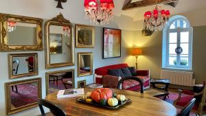 a living room with a table with fruit on it at Gite Hotel de maître centre village la Chapelle in Lyons-la-Forêt