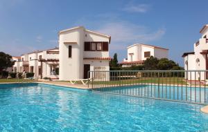a villa with a swimming pool in front of a building at Yucas Homes in Cala en Blanes