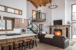 a kitchen and living room with a fireplace at Wildridge Chalet in Big Sky