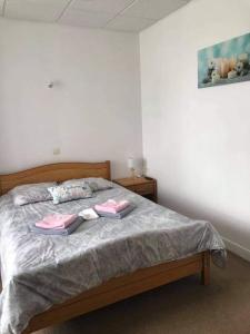 a bedroom with a bed with two towels on it at Hotel le faubourg in La Guerche-de-Bretagne