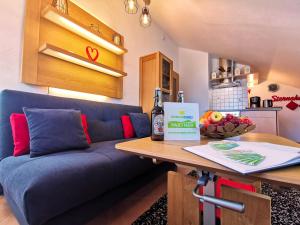 a living room with a blue couch and a table at Ferienhaus Alexandra in Nesselwang