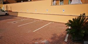 a brick parking lot with a car parked next to a building at Il Glicine in Verona