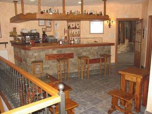 a bar in a restaurant with wooden stools at Hotel Villa Russell in Torla-Ordesa