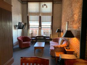 a living room with a couch and chairs and a table at The Palace Hotel in Port Townsend