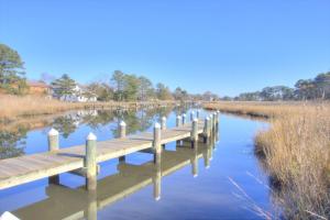 a wooden bridge over a river in a field at 34 Pier Point Dr, Millville in Millville