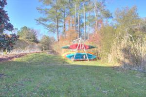a boat with a surfboard on it in a field at 34 Pier Point Dr, Millville in Millville