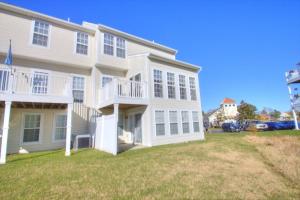 a large white house with a lawn in front of it at 34 Pier Point Dr, Millville in Millville