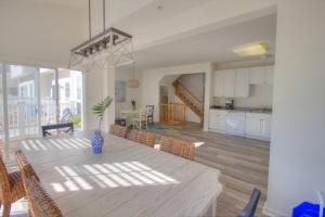 a dining room and kitchen with a table and chairs at 34 Pier Point Dr, Millville in Millville
