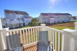 a balcony with two chairs and some houses at 34 Pier Point Dr in Millville