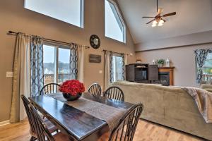a dining room with a table and a couch at Hilltop Osage Beach Home with Deck and Fire Pit! in Osage Beach