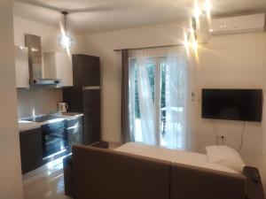 a living room with a couch and a kitchen at Apartment Tome in Biograd na Moru