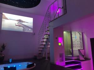 a purple bathroom with a staircase and a tub at Loft Deliciae in Remoulins