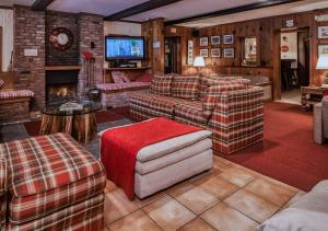 a large living room with couches and a fireplace at Kitzhof Inn Vermont in West Dover