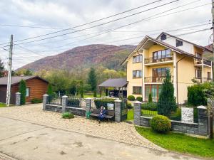 a child sitting on a bench in front of a house at Maria in Solochyn