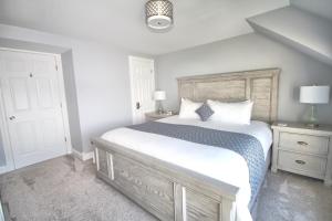 a bedroom with a large white bed and two night stands at 307 Water Street Inn in Boyne City
