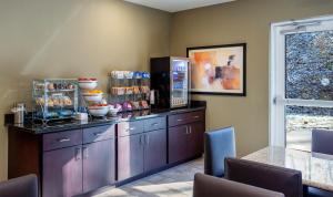 a kitchen with purple cabinets and a counter at Cobblestone Inn & Suites - Brookville in Brookville