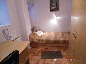 a small bedroom with a bed and a desk at Apartments Lavanda - Zagreb Centre in Zagreb