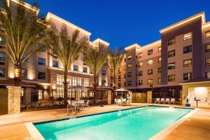 a swimming pool in front of a apartment building at Staybridge Suites Irvine - John Wayne Airport, an IHG Hotel in Irvine