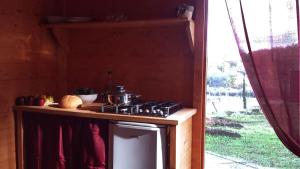 a stove with a pot on top of it in a kitchen at Agricampeggio Madonna di Pogi in Bucine