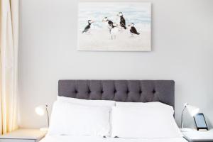1 dormitorio con 1 cama con pájaros en la playa en The Montana, en Torquay