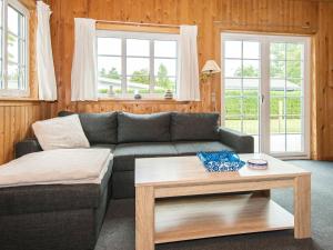 a living room with a couch and a coffee table at 4 person holiday home in Ansager in Ansager