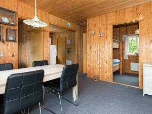 a dining room with a large wooden table and chairs at 4 person holiday home in Ansager in Ansager