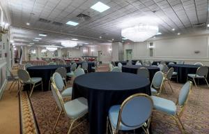 a banquet hall with tables and chairs in a room at Red Roof PLUS Newark Liberty Airport - Carteret in Carteret