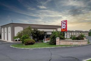 a large building with a sign in front of it at Red Roof PLUS Newark Liberty Airport - Carteret in Carteret