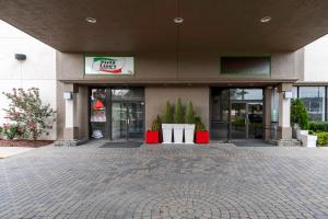 a store front of a shopping center with doors open at Red Roof PLUS Newark Liberty Airport - Carteret in Carteret