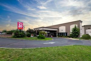 a building with a sign in front of it at Red Roof PLUS Newark Liberty Airport - Carteret in Carteret