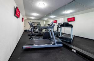 a gym with several tread machines in a room at Red Roof PLUS Newark Liberty Airport - Carteret in Carteret