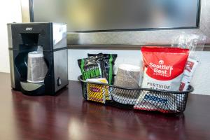 a basket sitting on a table next to a coffee maker at Red Roof PLUS Newark Liberty Airport - Carteret in Carteret