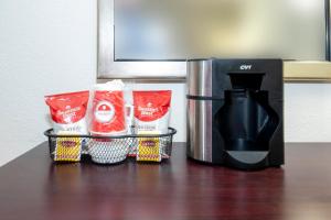 a counter with a coffee maker and a coffee pot at Red Roof PLUS Newark Liberty Airport - Carteret in Carteret