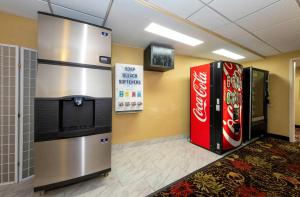 a lobby with two coke machines and a television at Red Roof PLUS Newark Liberty Airport - Carteret in Carteret